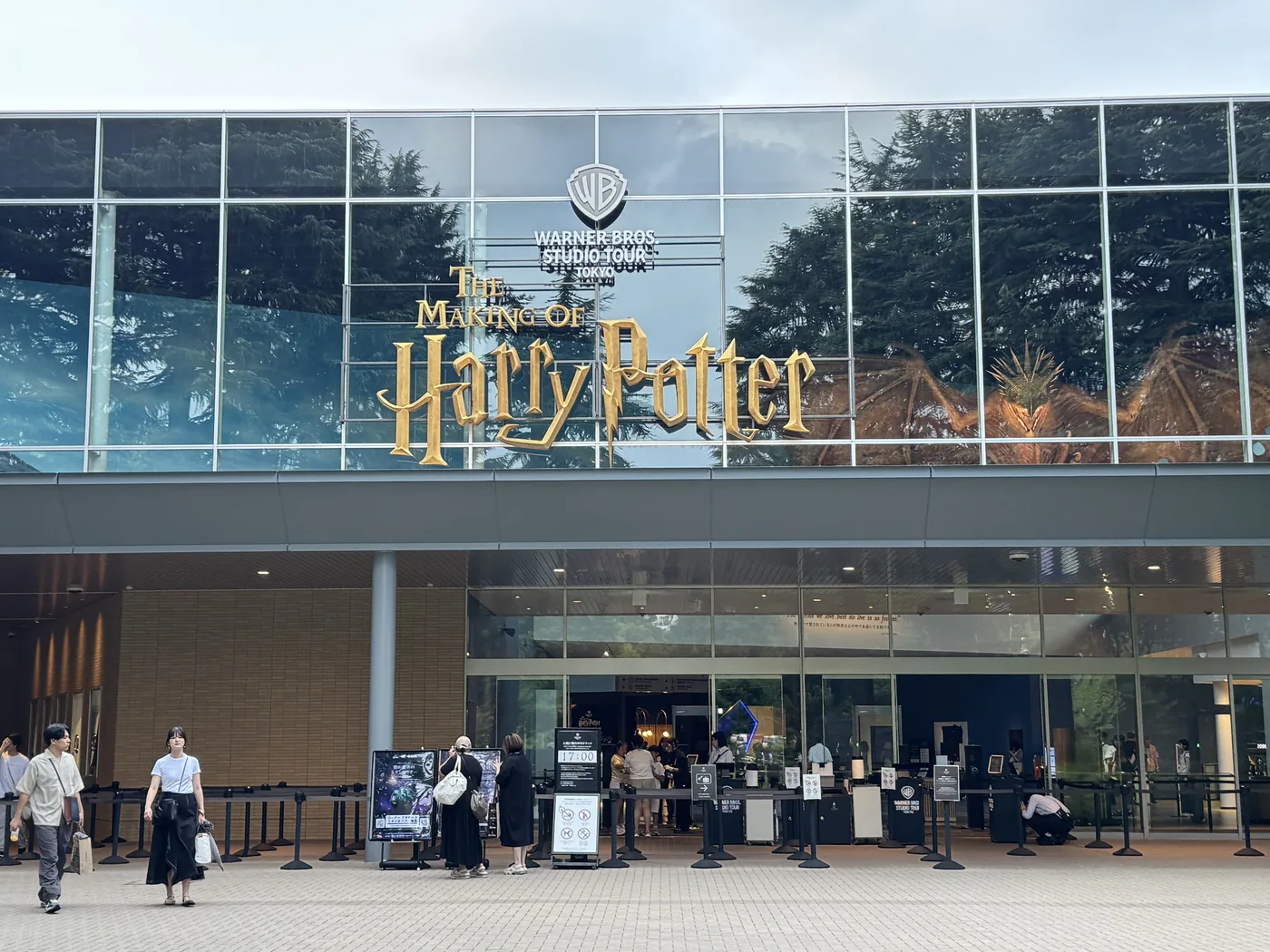 チケット窓口前の入場待機列 — 「THE MAKING OF Harry Potter」のサインと係員、来場者の列