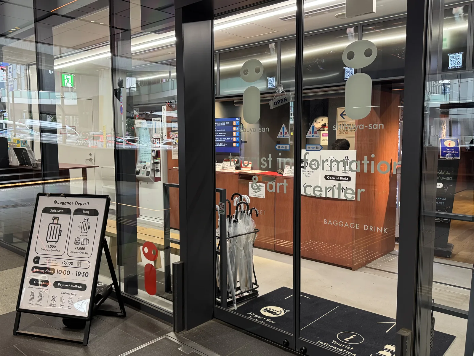 Inside a Shibuya exchange counter — a glass-fronted booth with currency trays, the kind of dedicated shop that beats hotel desks and street kiosks on rate