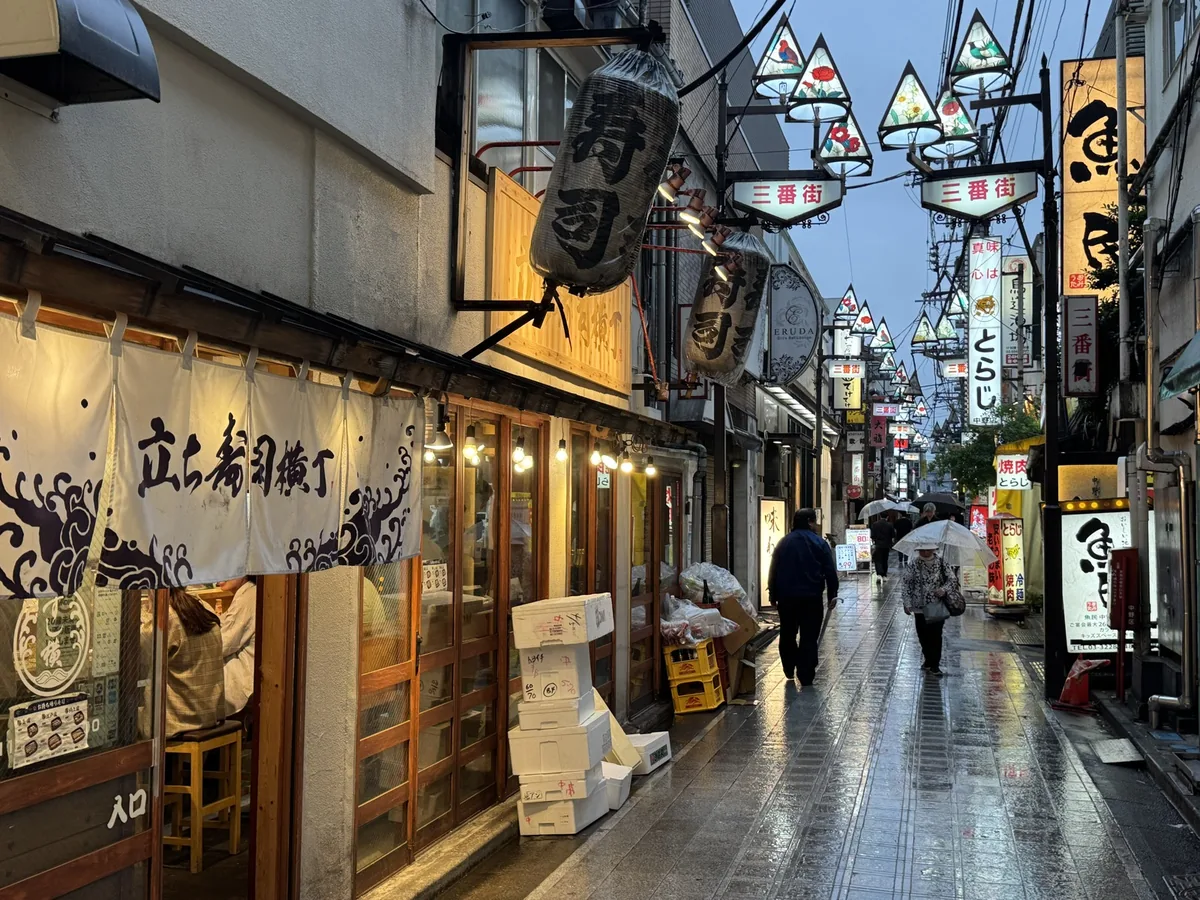 立ち寿司横丁の三番街、雨の路地提灯